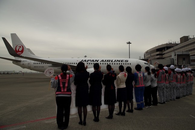 女性スタッフが並んで飛行機を見送った